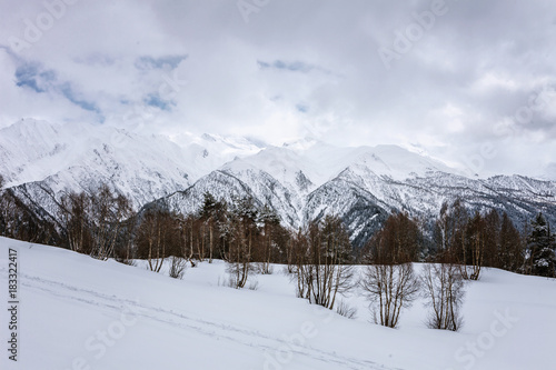 Fototapeta Naklejka Na Ścianę i Meble -  Panoramic view on snow winter mountains and cloud sky. Caucasus Mountains. Svaneti region of Georgia.