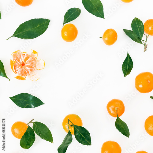 Fototapeta Naklejka Na Ścianę i Meble -  Frame made of mandarin with leaves on white background. Flat lay. Top view