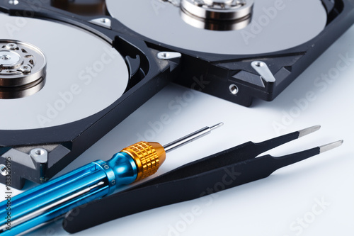 repair hard drive concept on white background with tools