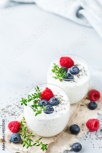 Healthy vegan white chia pudding with berries and green thyme