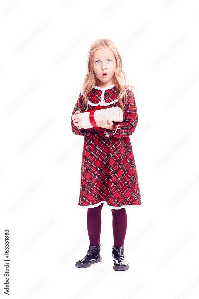 Isolated portrait of cute blonde little girl in checkered red dress holding gift box Isolated portrait of cute blonde little girl in checkered red dress holding gift box