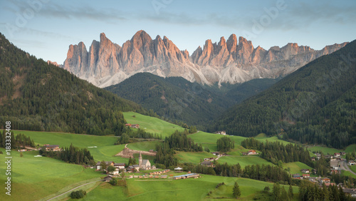 Small Italian mountain town of St. Magdalena in Val di Funes at sunset