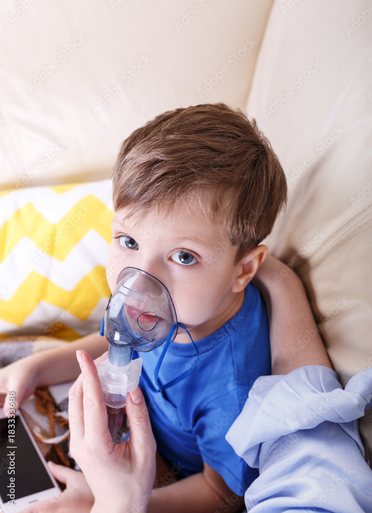 Boy breathe through nebulizer