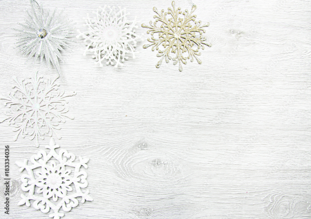 Fototapeta premium Christmas and New Year. Christmas toys, snowflakes on a wooden white background