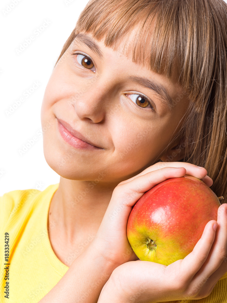 Portrait of little girl with fresh apple. Beautiful child wearing yellow t-shirt, holding fruit. Happy cute child on white background - close-up. Portrait of little girl with fresh apple. Beautiful child wearing yellow t-shirt, holding fruit. Happy cute child on white background - close-up.