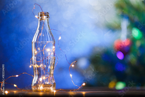 Photo of empty bottle with garland
