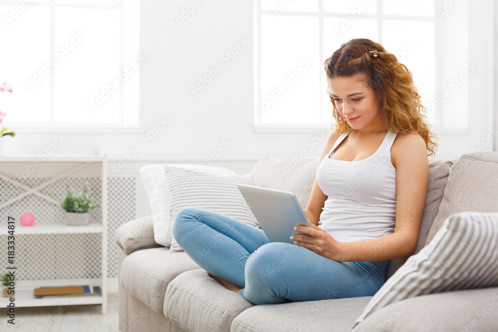 Young girl using digital tablet at home Young girl using digital tablet at home