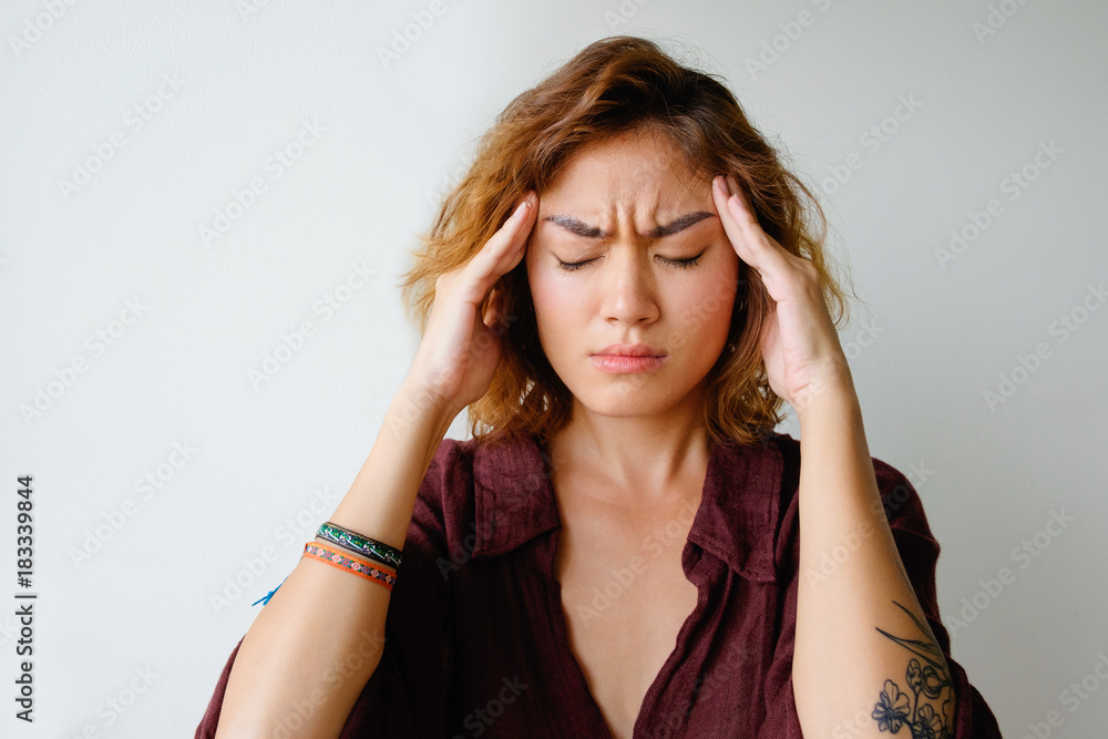 Fototapeta premium Portrait of tired young woman having headache