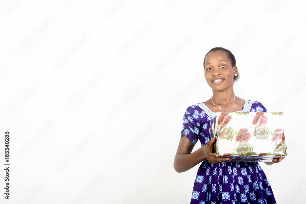African American lady holding gift boxes in her hands