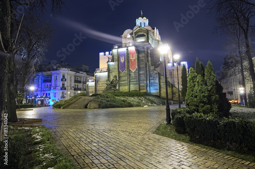 KYIV, UKRAINE: DECEMBER 03, 2017: Illuminated Golden Gates and Yaroslav the Wise monument. Selective focus with wide angle lens photo