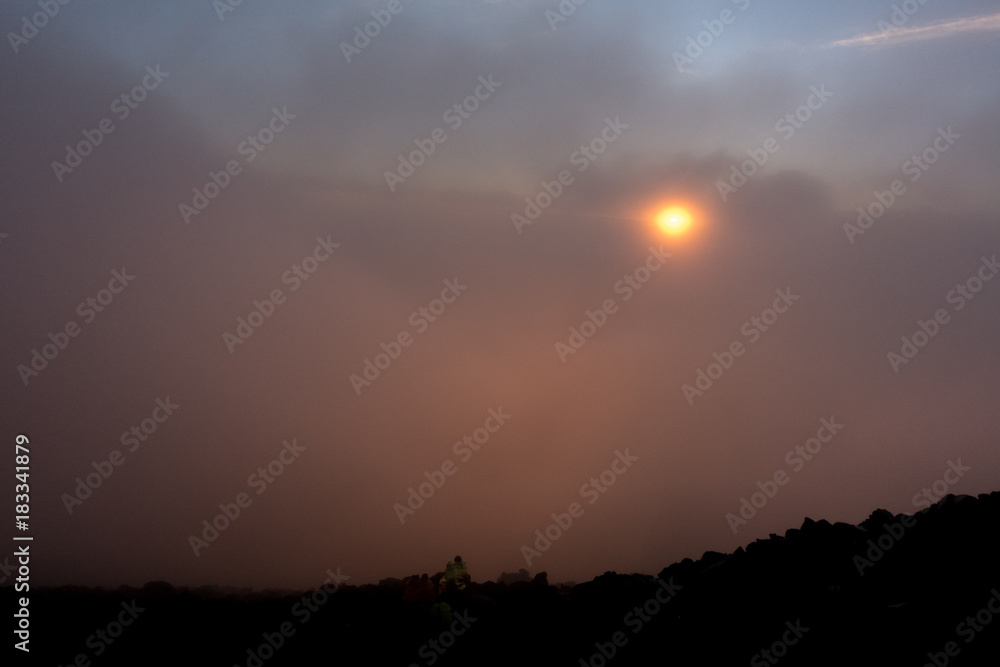 Orange sunset in the misty sky