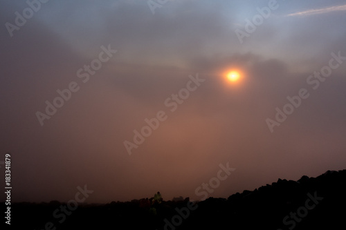 Orange sunset in the misty sky