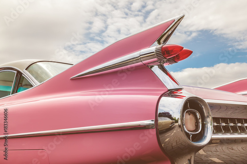 Rear end of a pink classic car