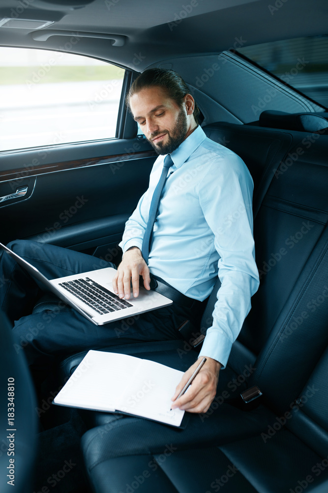 Portrait Of Business Man Working On Notebook, Traveling In Car.