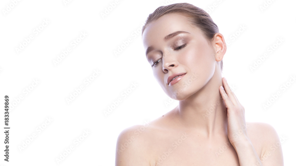 Obraz premium Beautiful brunette caucasian woman with fresh clean skin and neutral nude make-up and ponytail hairstyle posing sensually on a white isolated background. Young girl. Skincare. Copy space
