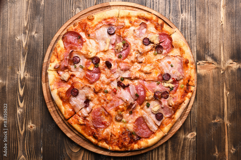 Italian dish on wooden tray. Pizza with bacon and cheese Italian dish on wooden tray. Pizza with bacon and cheese