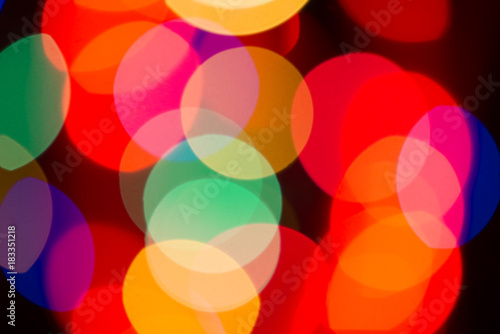Blurry multicolored spherical lights on black, can use background