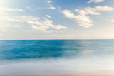 The Balearic sea in Spain. Soft Wave Of Blue Ocean On Sandy Beach. Background. Selective focus.Summer outdoor nature harmony. Summer holiday serenity.
