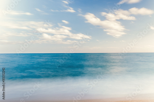 The Balearic sea in Spain. Soft Wave Of Blue Ocean On Sandy Beach. Background. Selective focus.Summer outdoor nature harmony. Summer holiday serenity.
