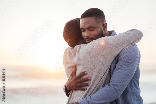 Content young African couple embracing each other at the beach Fototapet