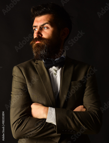 Man in retro suit and vest on brown background photo