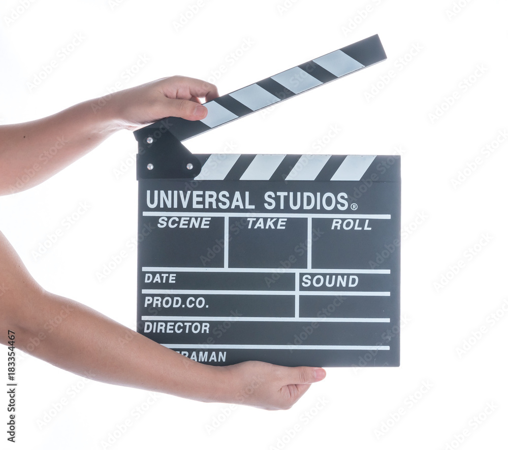Woman holding movie production clapper board isolated on a white background