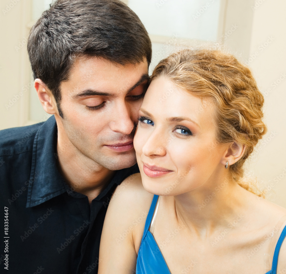 Cheerful smiling young couple, indoors Cheerful smiling young couple, indoors