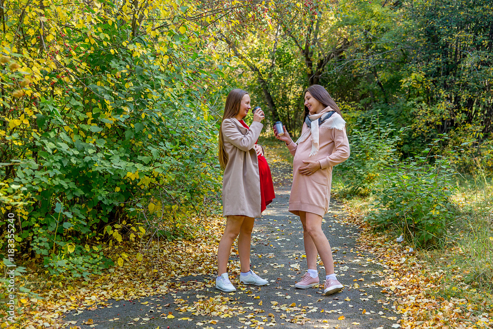 Fototapeta premium Pregnant woman walking in a park