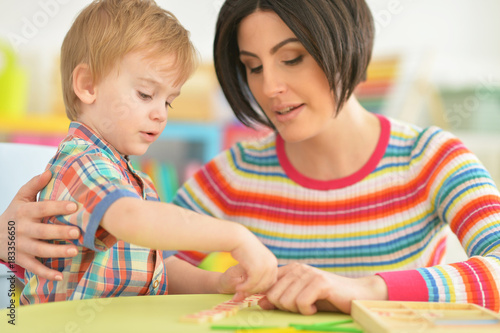 Young mother playing with son