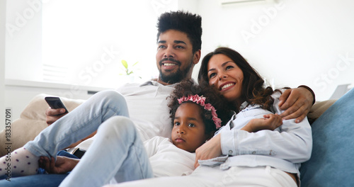 Happy family watching television at their home