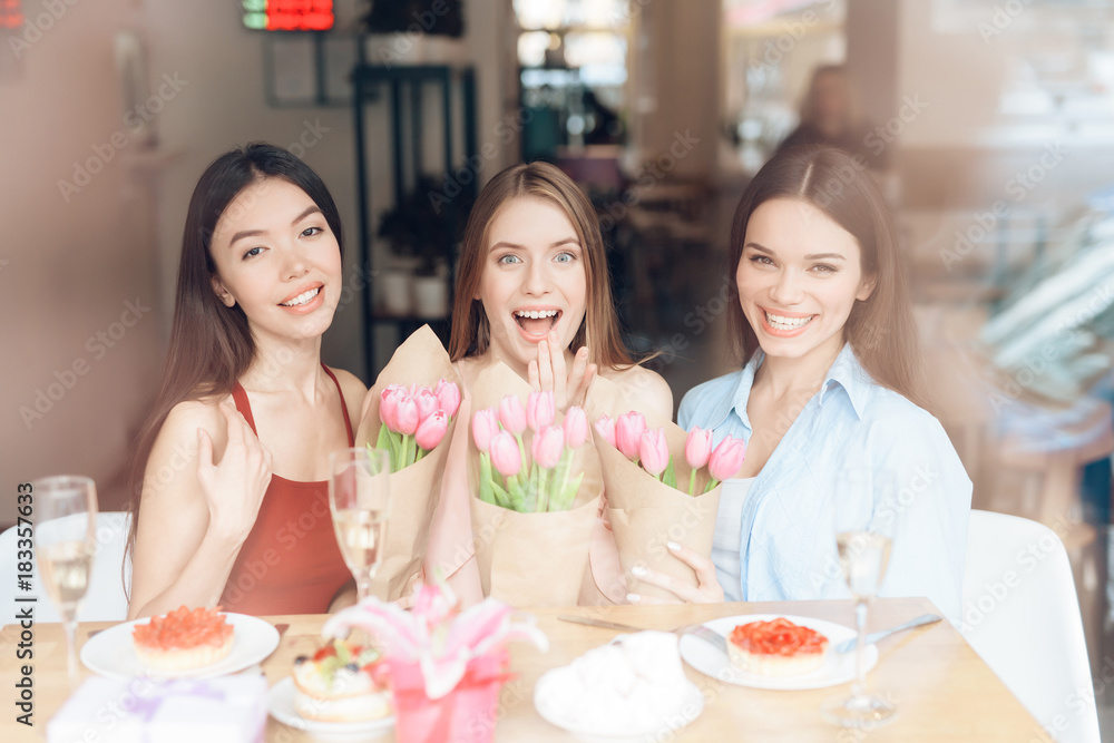 Three girls are sitting together in a cafe. Three girls are sitting together in a cafe.