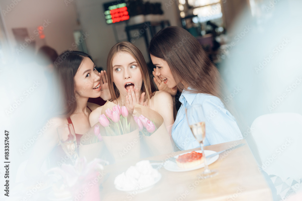 Three girls are sitting together in a cafe. Three girls are sitting together in a cafe.