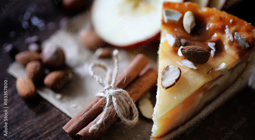 Fototapeta premium Pie with cinnamon and apples on a wooden table. Fresh pastry wit