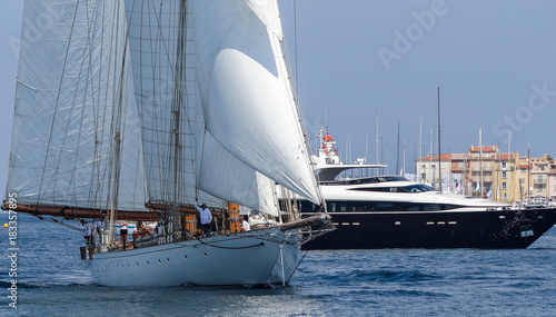 Sailing yacht and motorboat on anchorage of St. Tropez Bay