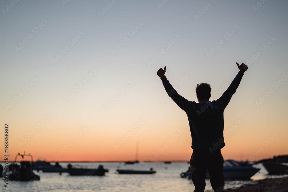 Fototapeta premium Man watching the sunrise in Portugal