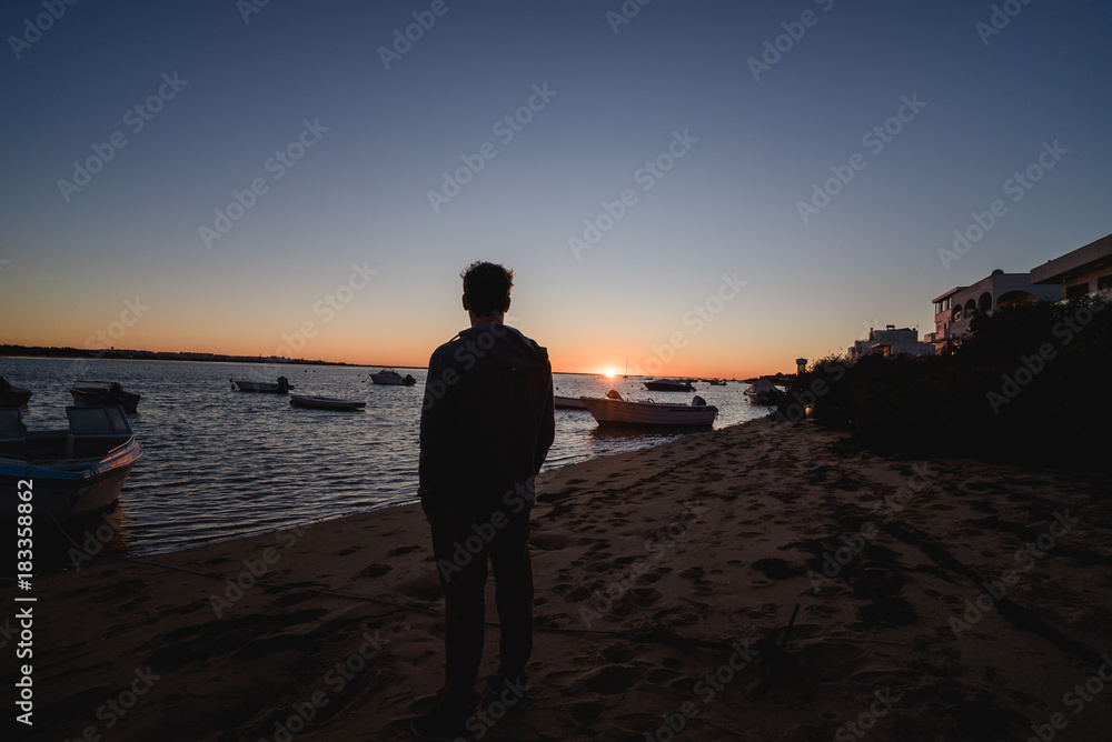 Man watching the sunrise in Portugal