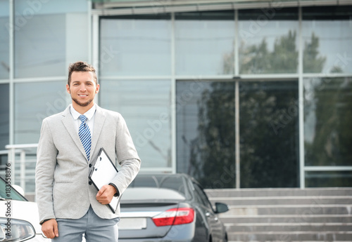 Salesman standing near new ...