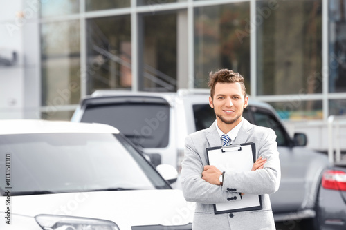 Salesman standing near new ...