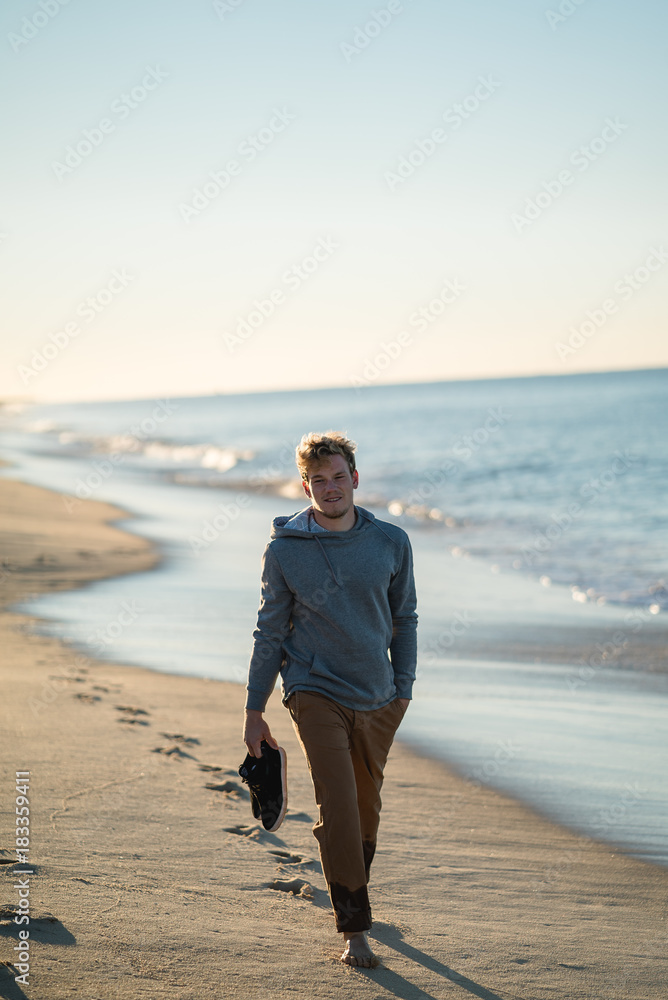 Man watching the sunrise and walking around on the beach in Portugal Man watching the sunrise and walking around on the beach in Portugal