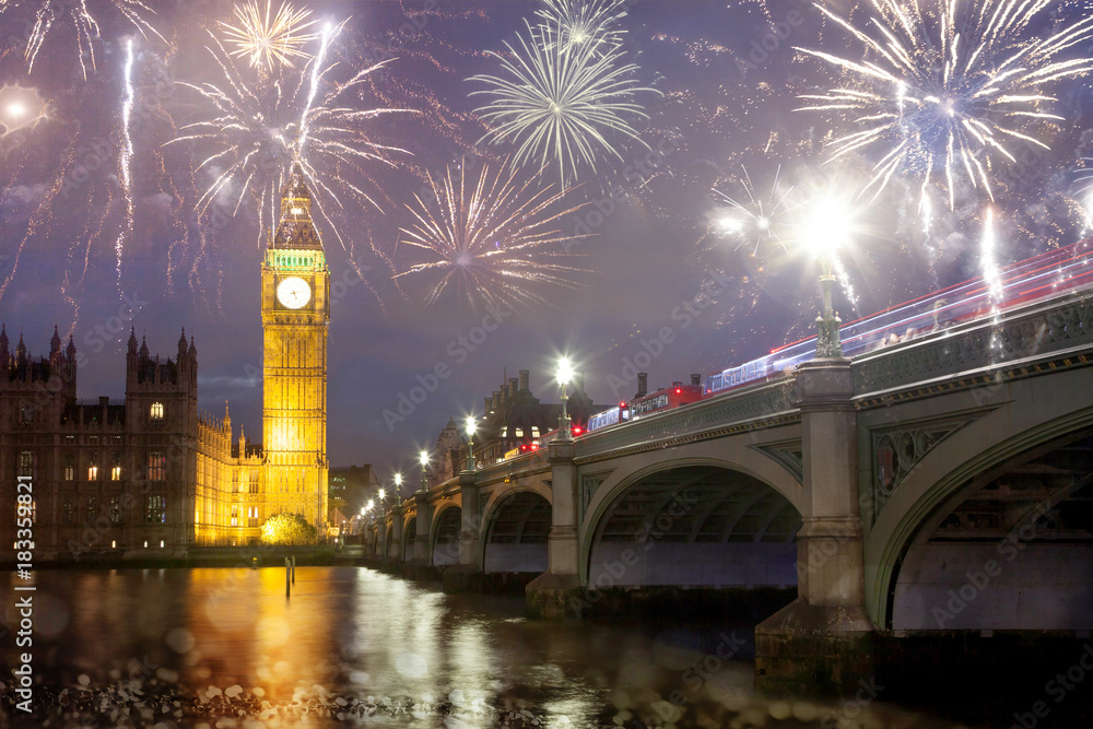 Fototapeta premium explosive fireworks display fills the sky around Big Ben. New Year's Eve celebration in the city