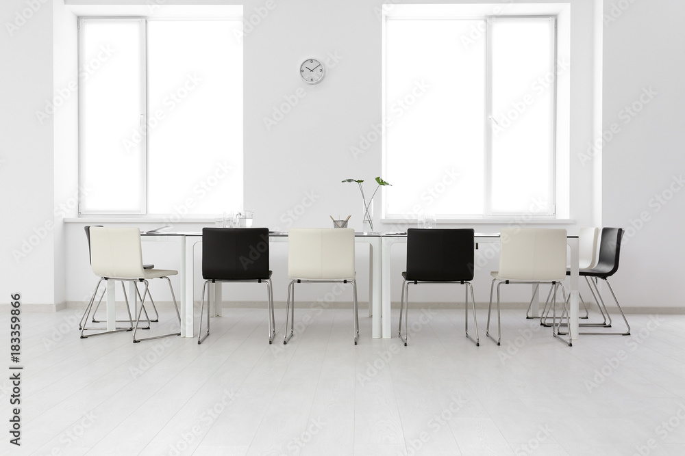 Modern office interior with large table and chairs