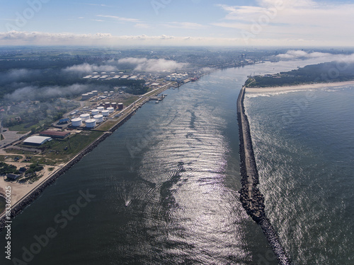 Aerial view over Klaipeda pier entrance to the Baltic sea in Lithuania, during summer time.	