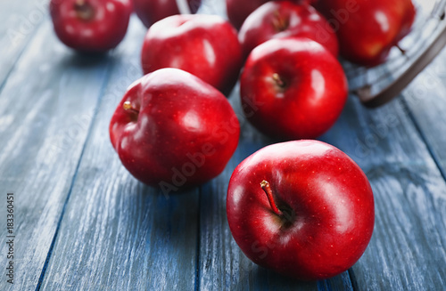 Ripe red apples on wooden background