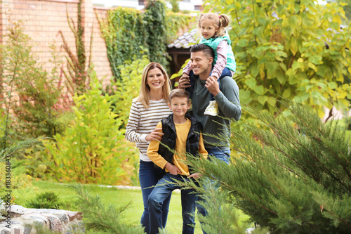 Happy family in garden near...