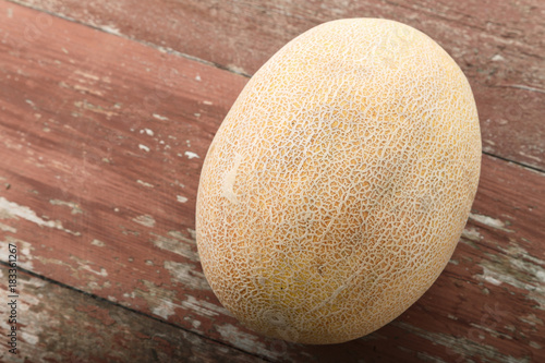 a whole ripe melon on  table. Space for text