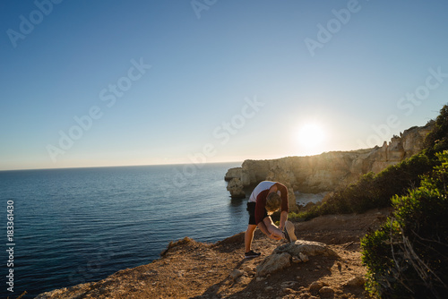 Stretching on a cliff in Portugal © Nena