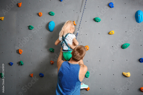 Instructor helping little g...