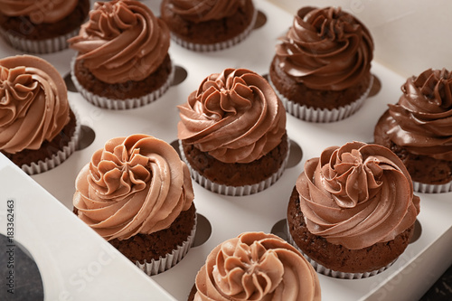 Delicious chocolate cupcakes in cardboard box