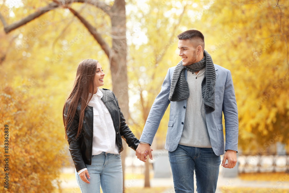 Young couple walking in park on autumn day Young couple walking in park on autumn day