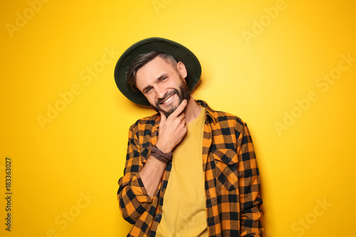 Quadro em tela Portrait of handsome young hipster man on color background